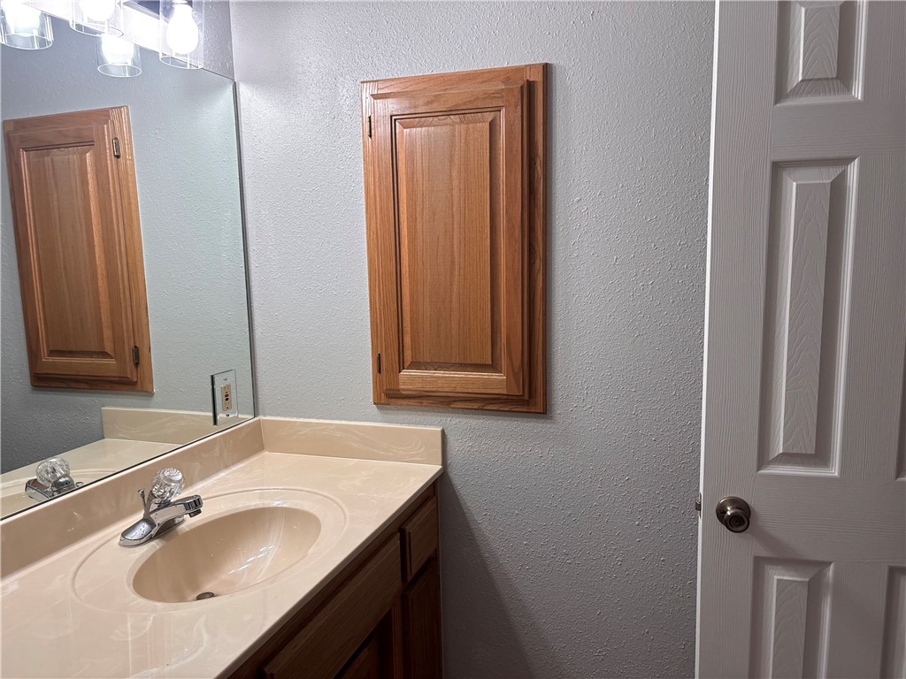 15262 Shipe Road Gravette, AR 72736 - Photo 44 of 60 Bathroom vanity with an integrated sink and reflective surface