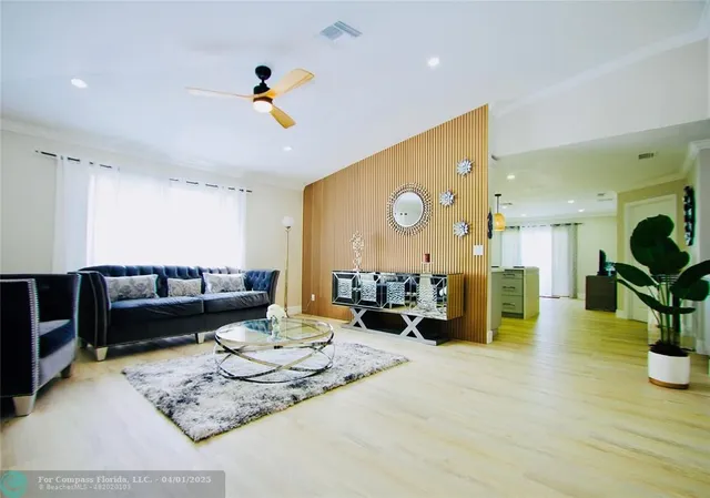 a living room with furniture and wooden floor