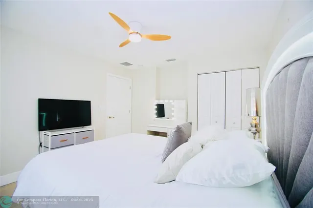 a bedroom with a bed and a flat screen tv