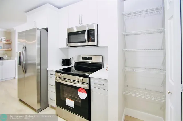 a kitchen with a refrigerator stove and microwave