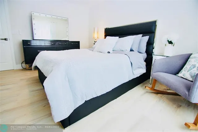 a bed sitting in a bedroom next to a couch