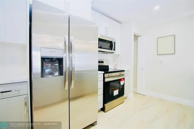 a kitchen with stainless steel appliances a refrigerator and a stove