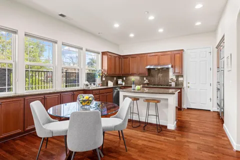 a view of a dining room with furniture window and wooden floor