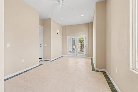 an aerial view of residential houses with outdoor space and trees