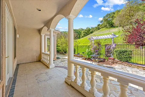 an aerial view of residential houses with outdoor space and trees