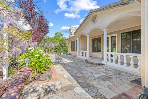 a view of a swimming pool with a yard and sitting area