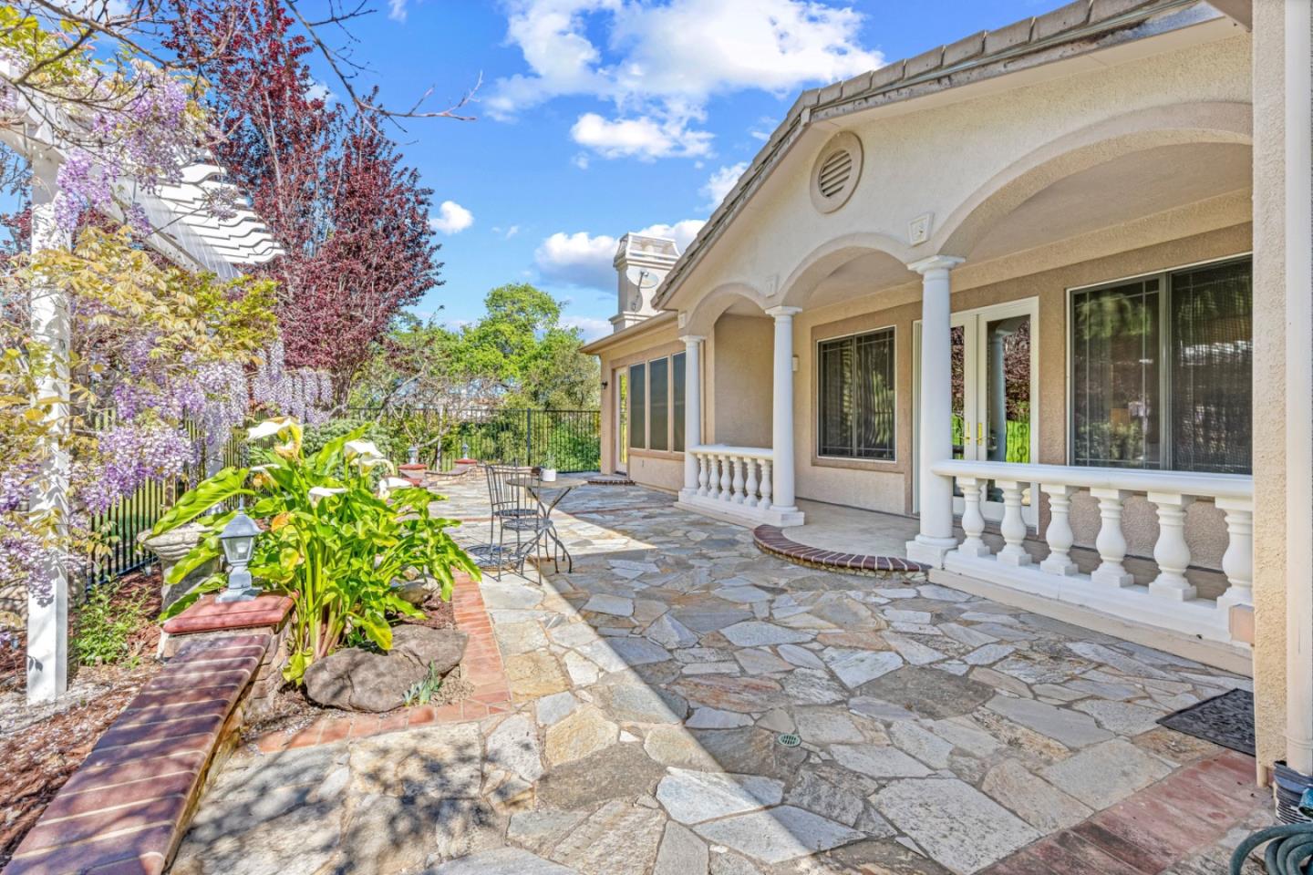 7071 Eagle Ridge Drive Gilroy, CA 95020 - Photo 48 of 72 a view of a white house with a bench next to a yard