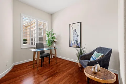 a living room with furniture a fireplace and a table