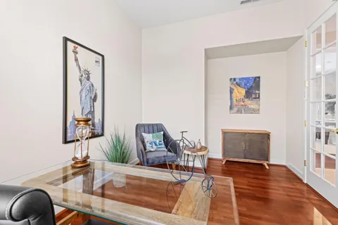 a living room with furniture a fireplace and a large window