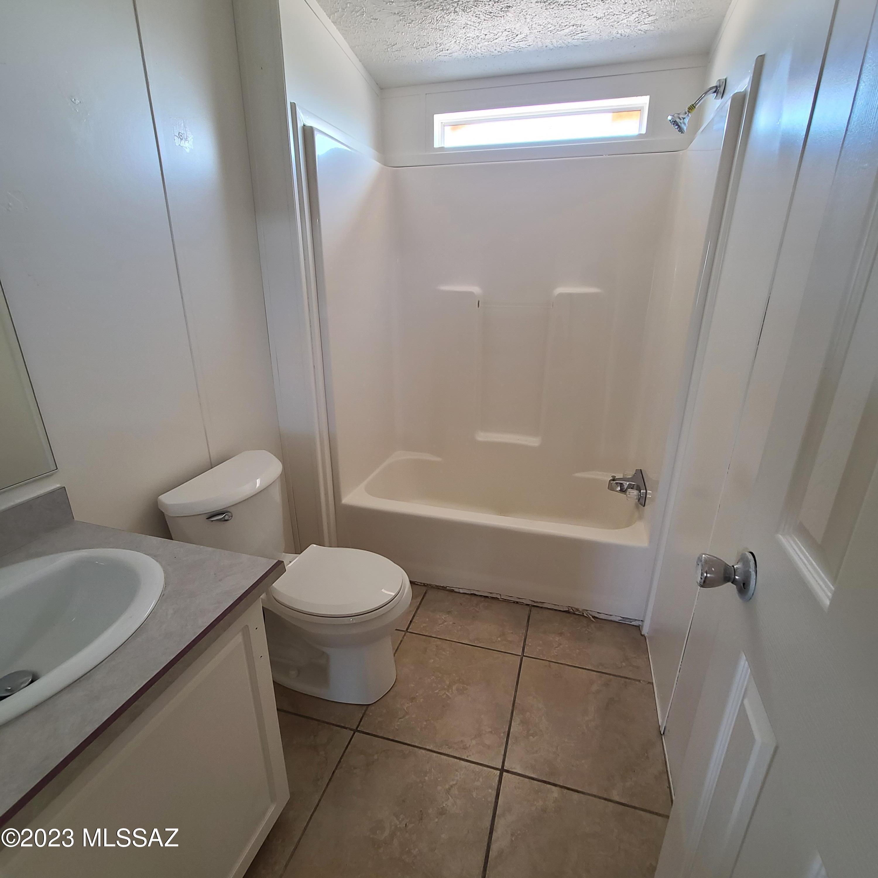 8896 South Marstellar Road Tucson, AZ 85736 - Photo 18 of 39 a bathroom with a toilet and a shower
