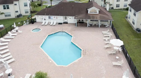 an aerial view of a house with swimming pool patio and outdoor seating