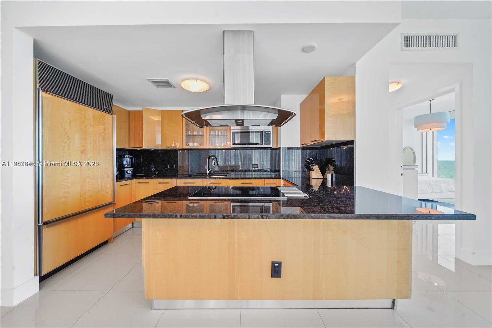 6899 Collins Avenue, Unit 808 Miami Beach, FL 33141 - Photo 17 of 31 a view of a kitchen with stainless steel appliances granite countertop a stove and a sink