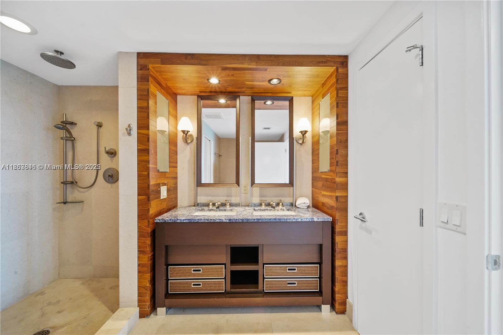 6899 Collins Avenue, Unit 808 Miami Beach, FL 33141 - Photo 23 of 31 a bathroom with a sink mirror and shower