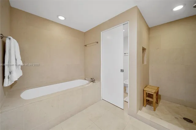a bathroom with a tub and a shower