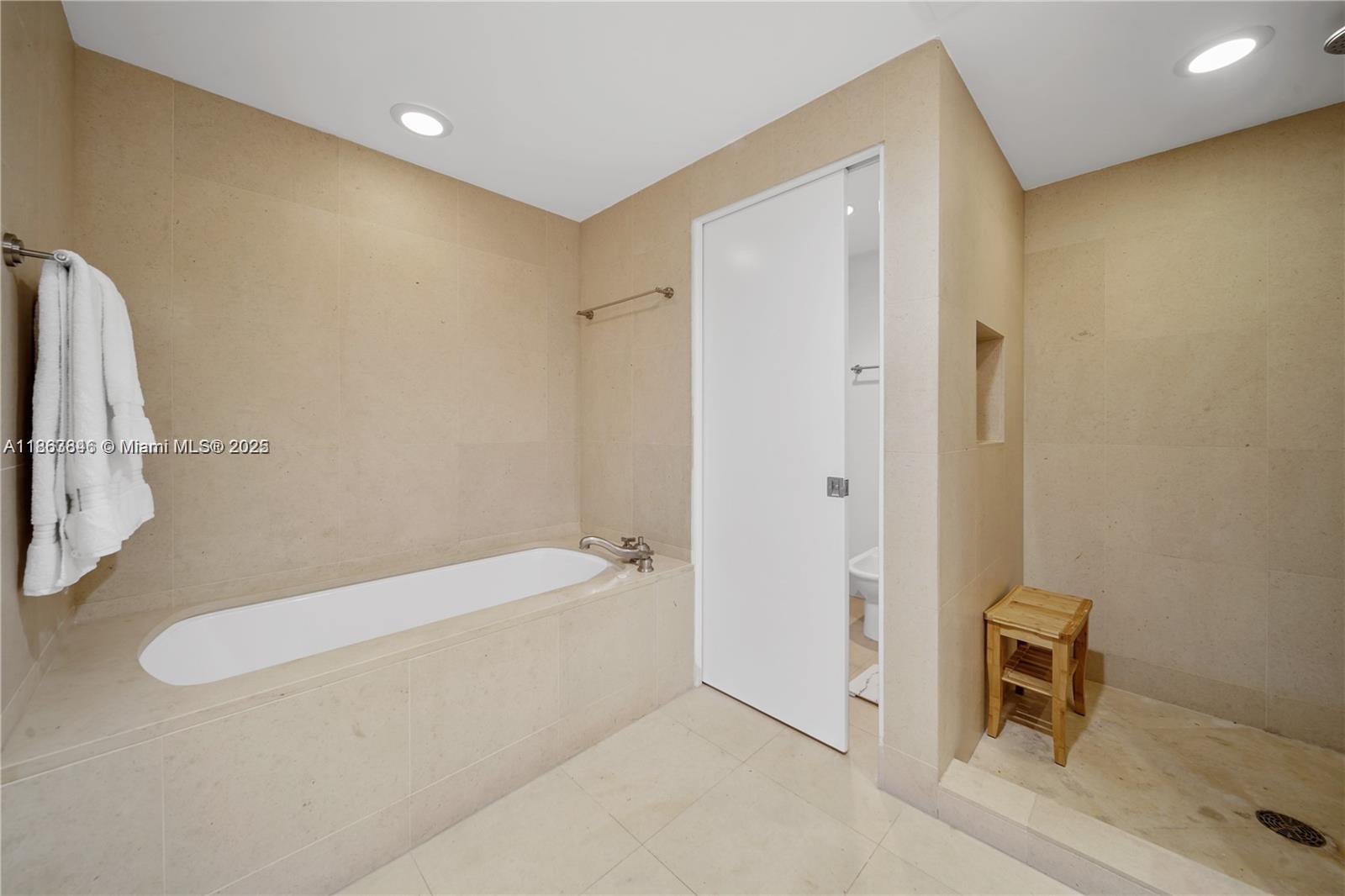 6899 Collins Avenue, Unit 808 Miami Beach, FL 33141 - Photo 25 of 31 a bathroom with a tub and a shower