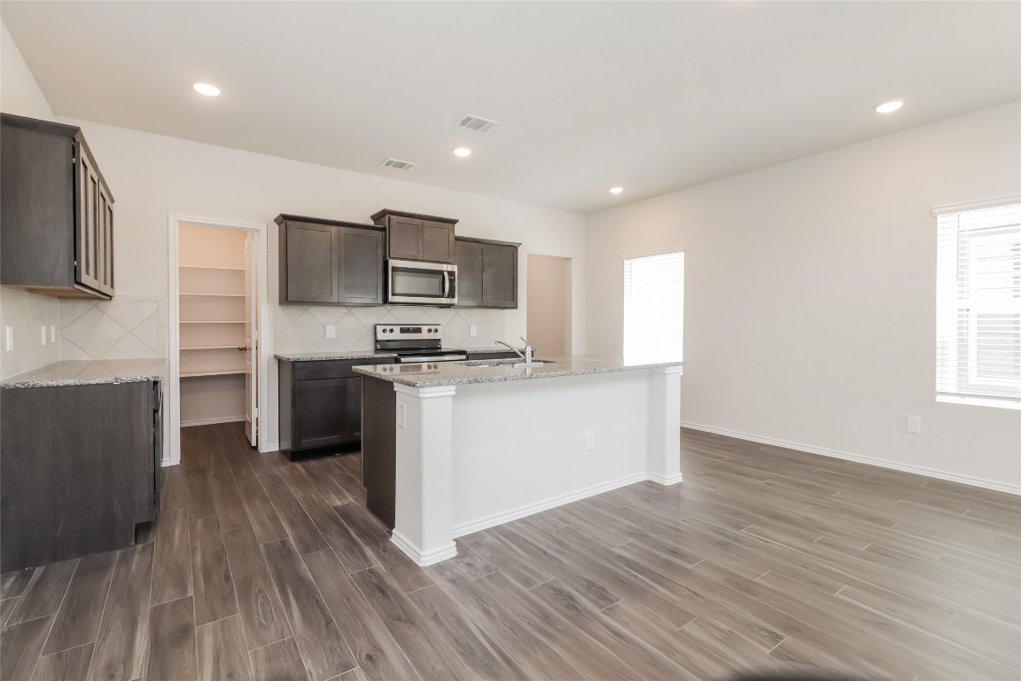 15200 Estrella Road East Houston, TX 77073 - Photo 2 of 13 a kitchen with stainless steel appliances a refrigerator and a stove top oven