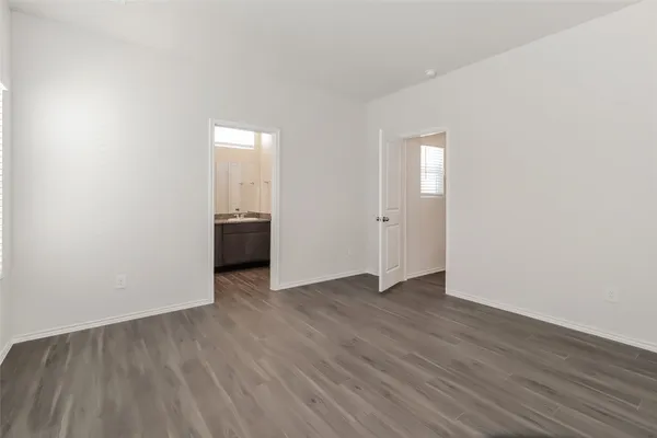 an empty room with wooden floor and closet