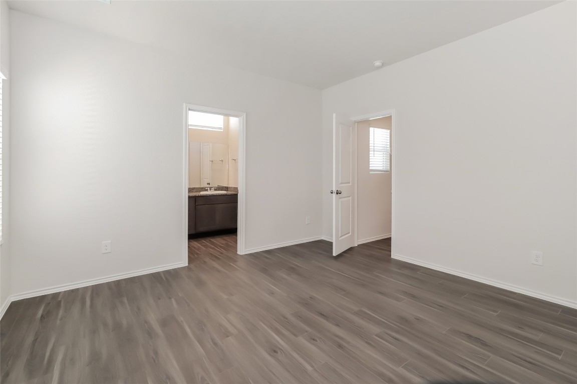 15200 Estrella Road East Houston, TX 77073 - Photo 6 of 13 an empty room with wooden floor and closet
