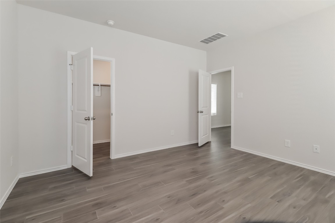 15200 Estrella Road East Houston, TX 77073 - Photo 7 of 13 a view of an empty room with wooden floor and a window