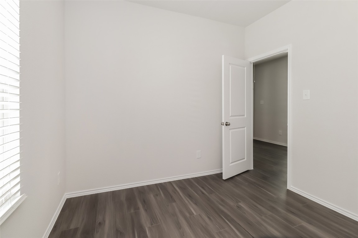 15200 Estrella Road East Houston, TX 77073 - Photo 10 of 13 an empty room with wooden floor and windows