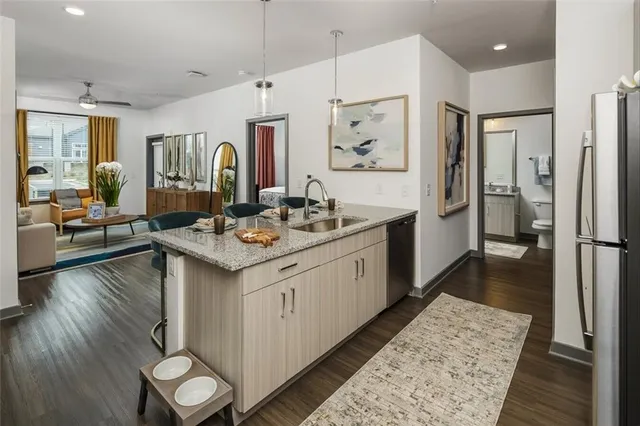 a bathroom with a sink double vanity granite and a shower