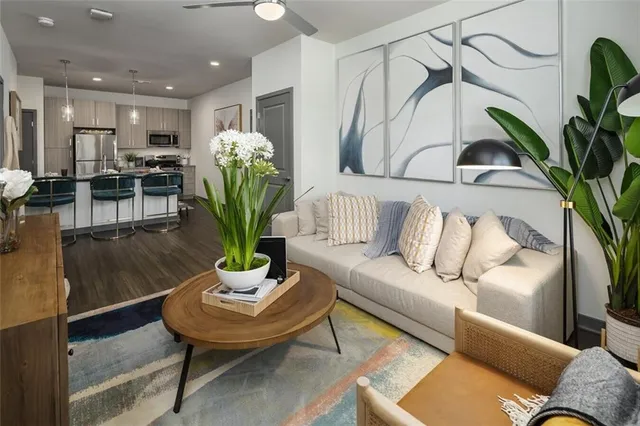 a living room with furniture flowerpot and a potted plant