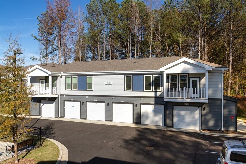 191 Commerce Drive, Unit B1 Villa Rica, GA 30180 - Photo 28 of 30 a front view of a house with a yard and garage