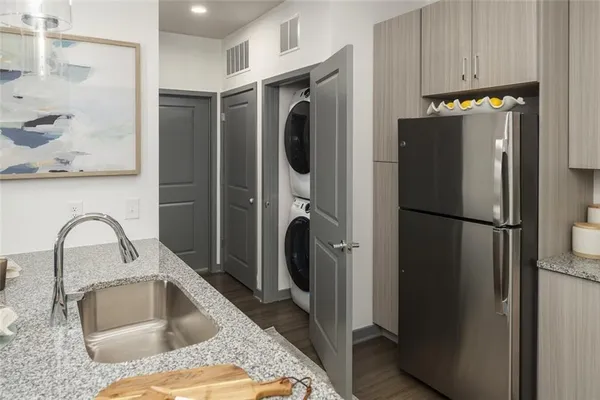 a kitchen with a refrigerator and a sink