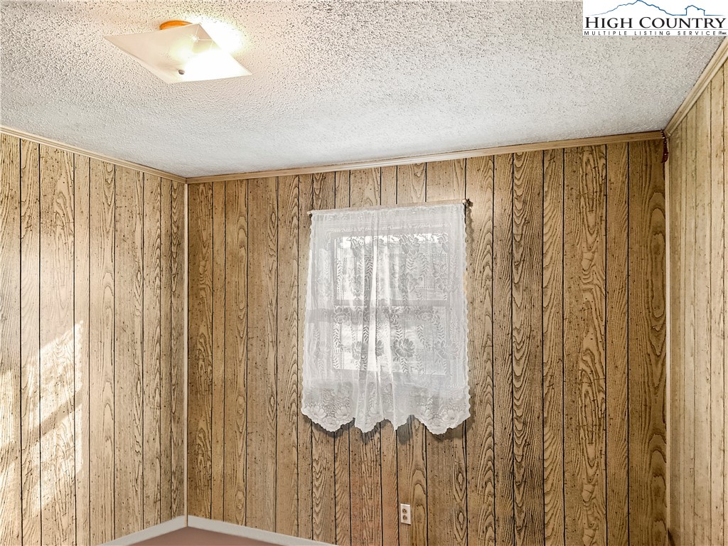 2496 Tucker Road Lansing, NC 28643 - Photo 15 of 20 a bathroom with a shower and a large mirror