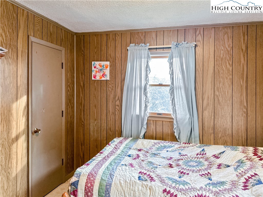 2496 Tucker Road Lansing, NC 28643 - Photo 18 of 20 a bedroom with a bed and a window