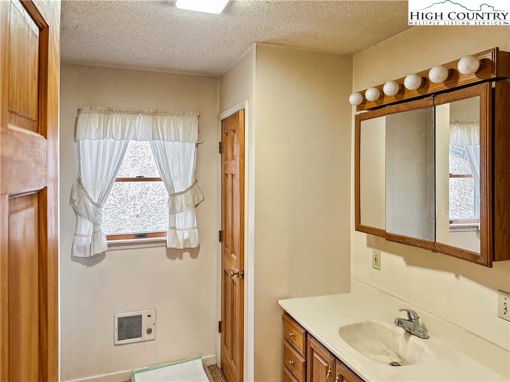 2496 Tucker Road Lansing, NC 28643 - Photo 19 of 20 a bathroom with a sink and a mirror