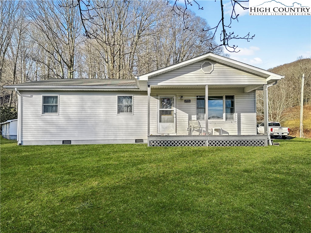 2496 Tucker Road Lansing, NC 28643 - Photo 2 of 20 a front view of a house with a garden