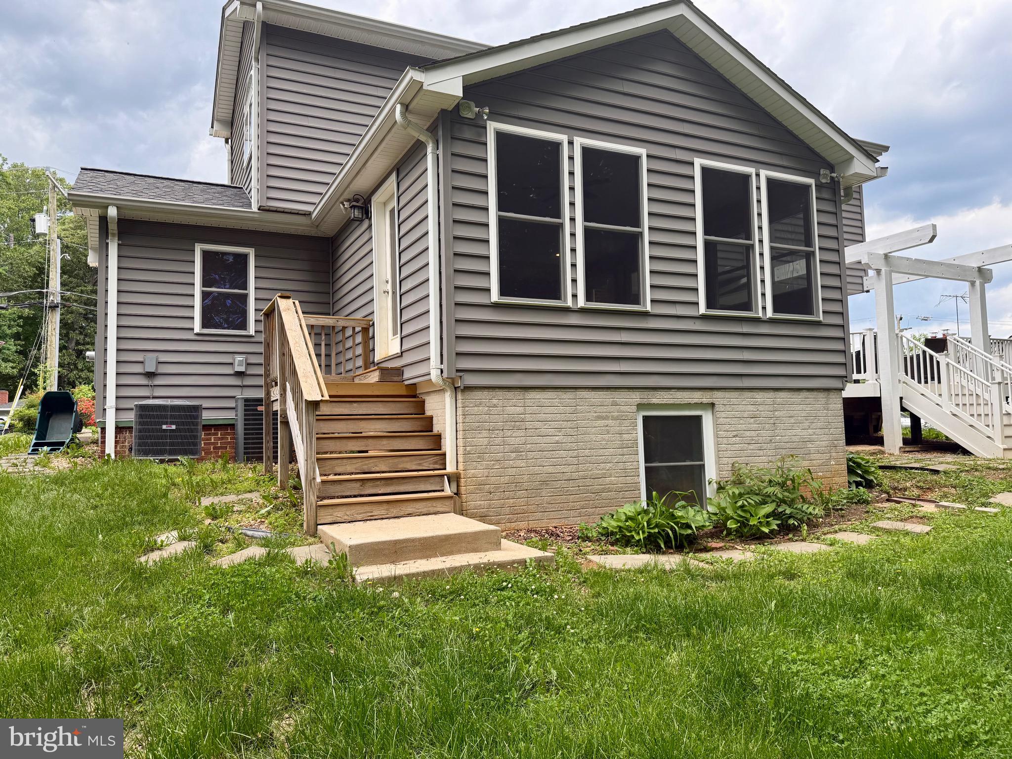 6605 Keene Drive Springfield, VA 22152 - Photo 17 of 127 a front view of a house with a yard