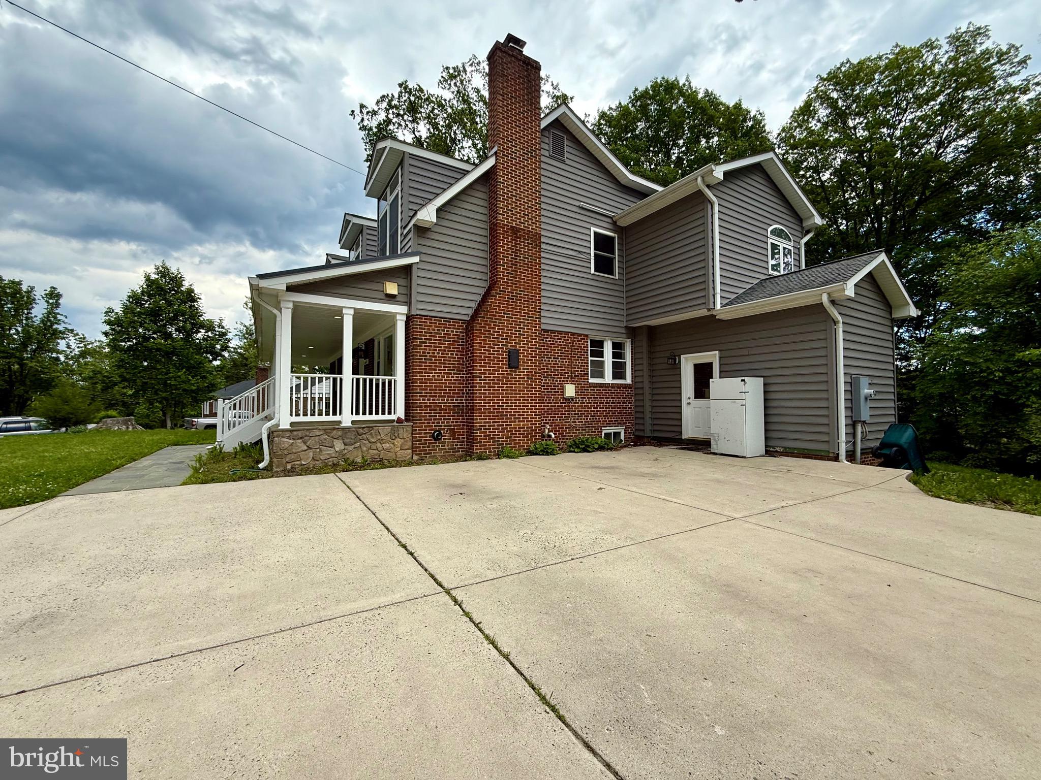 6605 Keene Drive Springfield, VA 22152 - Photo 18 of 127 a front view of a house with a yard and garage