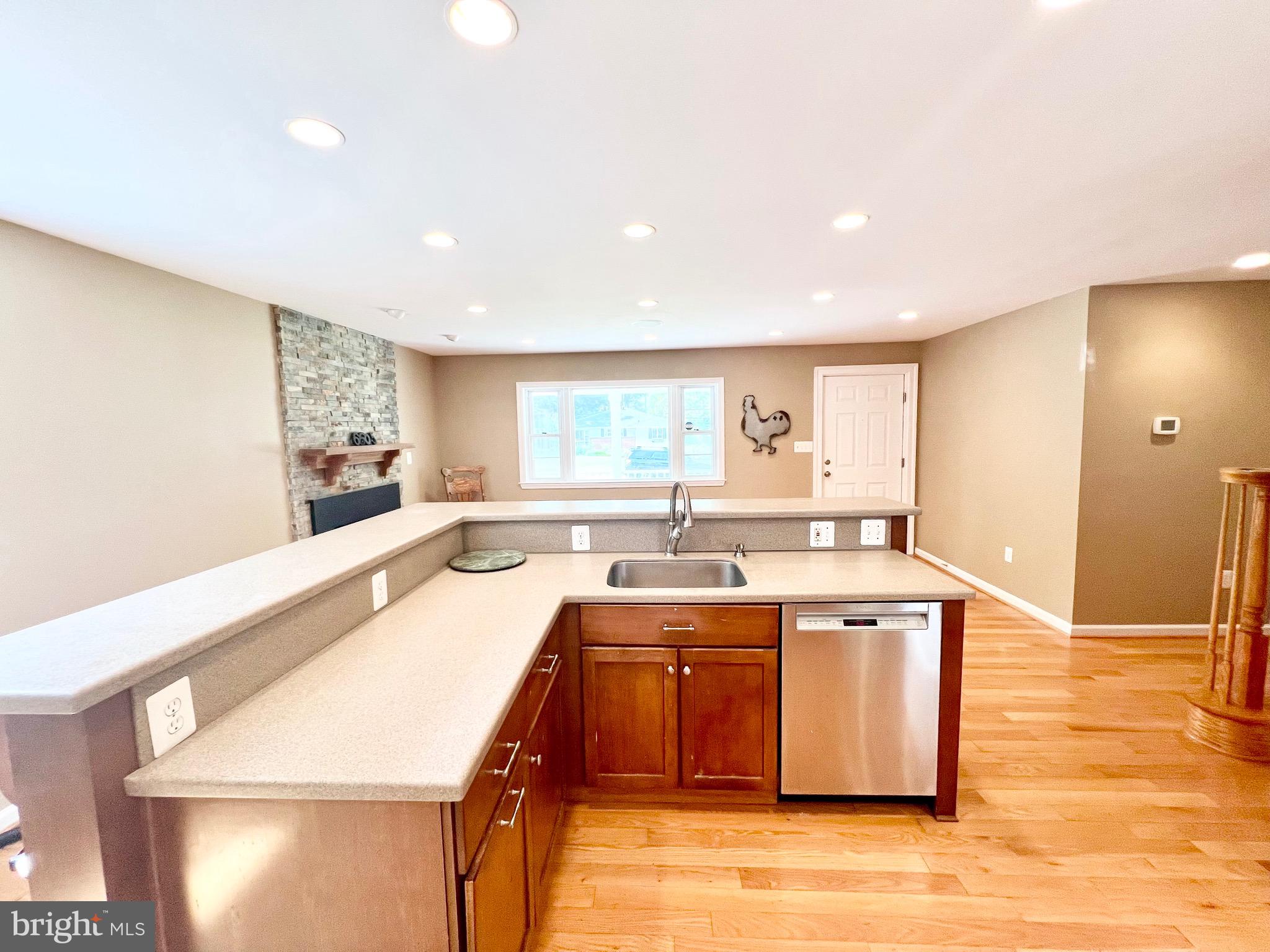 6605 Keene Drive Springfield, VA 22152 - Photo 37 of 127 a large kitchen with a large counter top a sink a window and stainless steel appliances