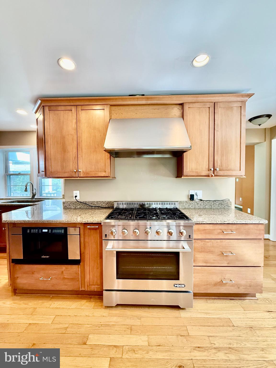 6605 Keene Drive Springfield, VA 22152 - Photo 40 of 127 a kitchen with stainless steel appliances granite countertop a stove a sink and a microwave