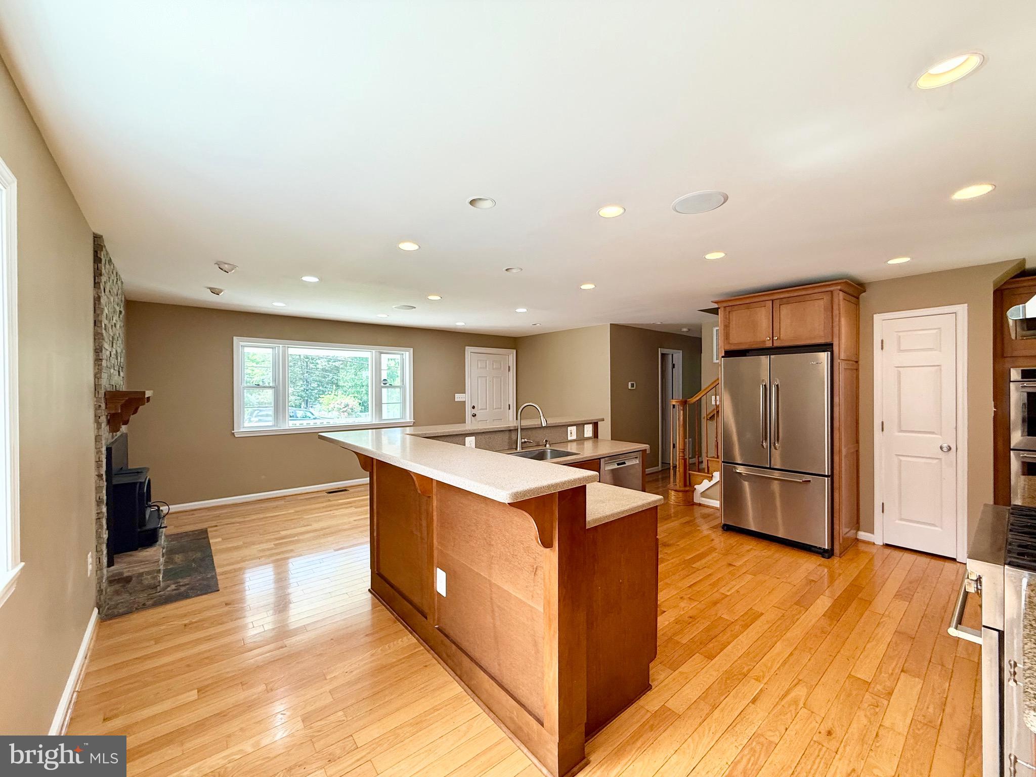 6605 Keene Drive Springfield, VA 22152 - Photo 44 of 127 a kitchen with stainless steel appliances granite countertop a refrigerator and a stove top oven