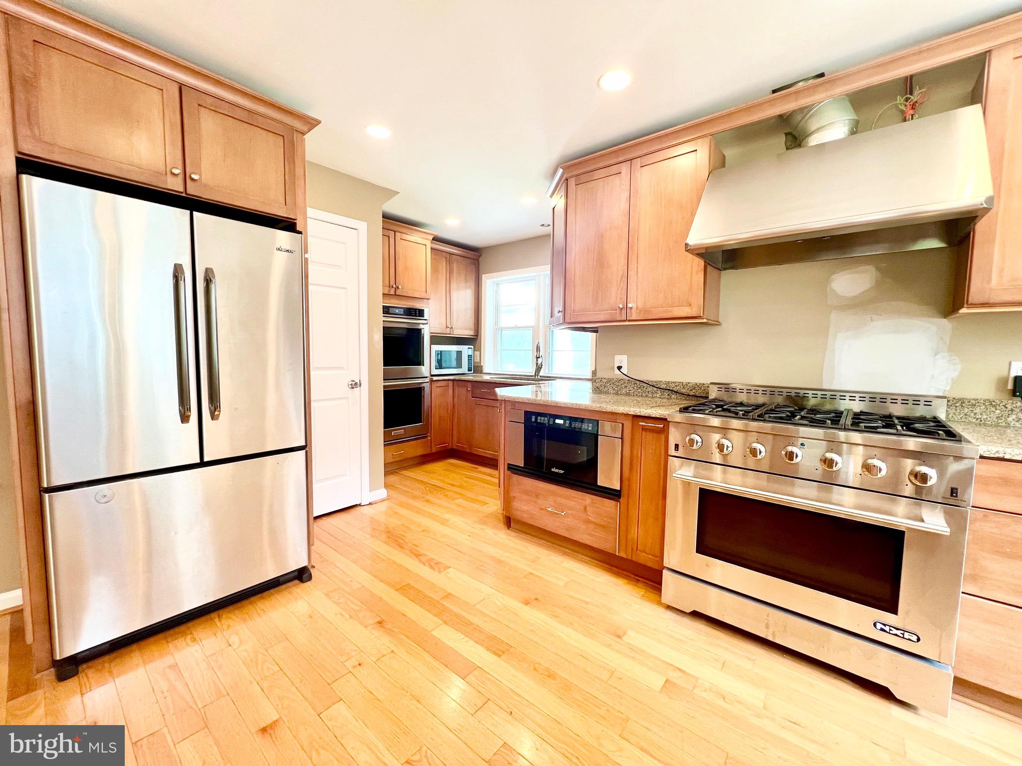 6605 Keene Drive Springfield, VA 22152 - Photo 47 of 127 a kitchen with stainless steel appliances a stove a sink and a refrigerator