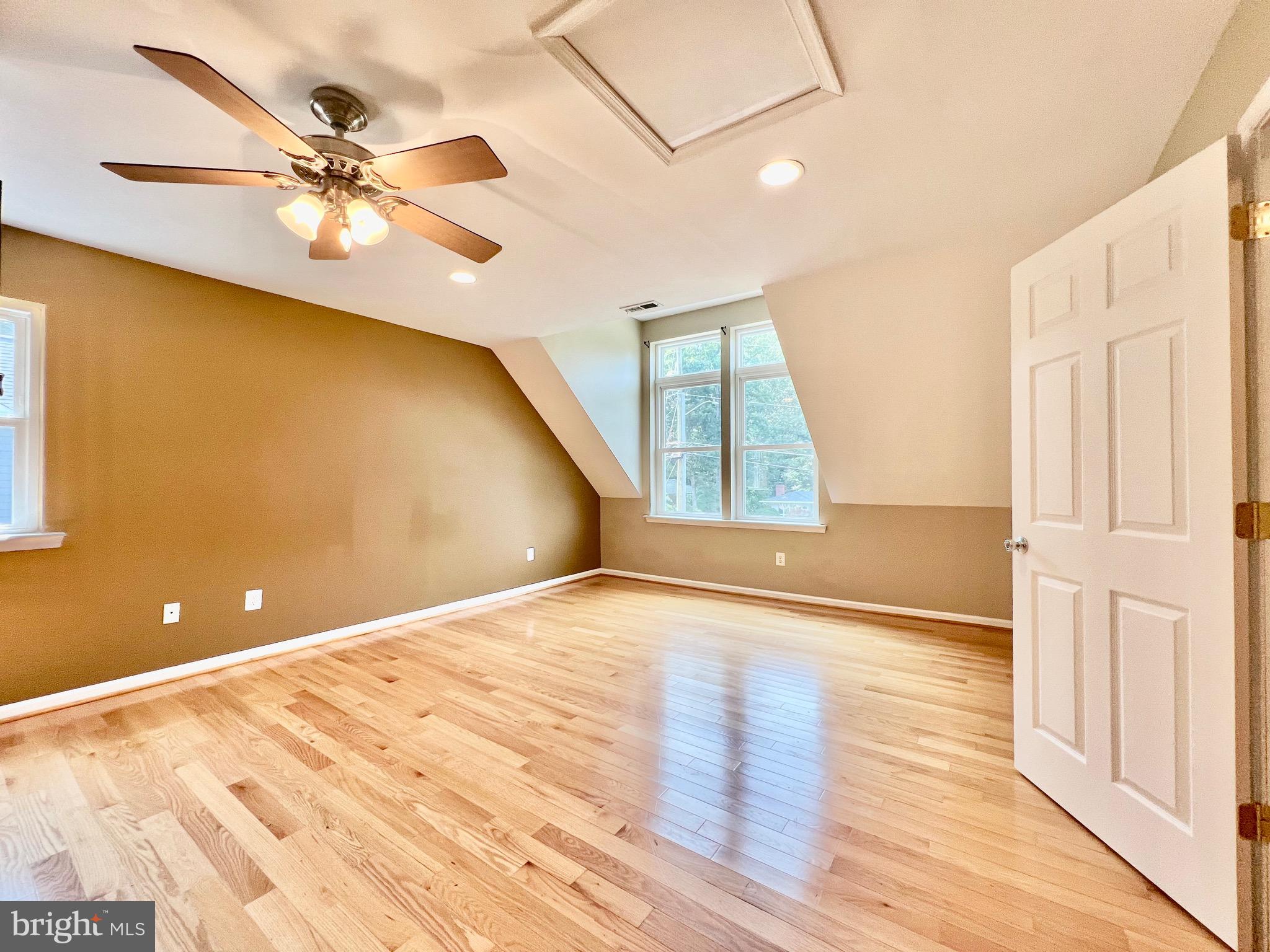 6605 Keene Drive Springfield, VA 22152 - Photo 6 of 127 a view of an empty room with wooden floor and a ceiling fan
