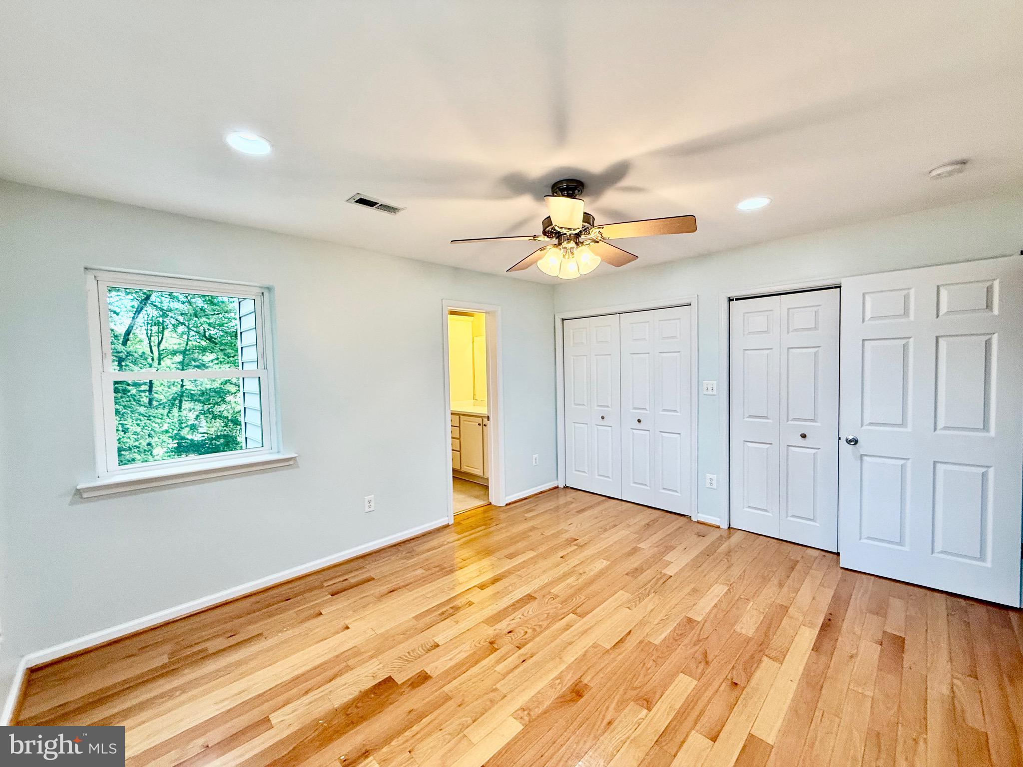 6605 Keene Drive Springfield, VA 22152 - Photo 90 of 127 a view of an empty room with wooden floor and a window