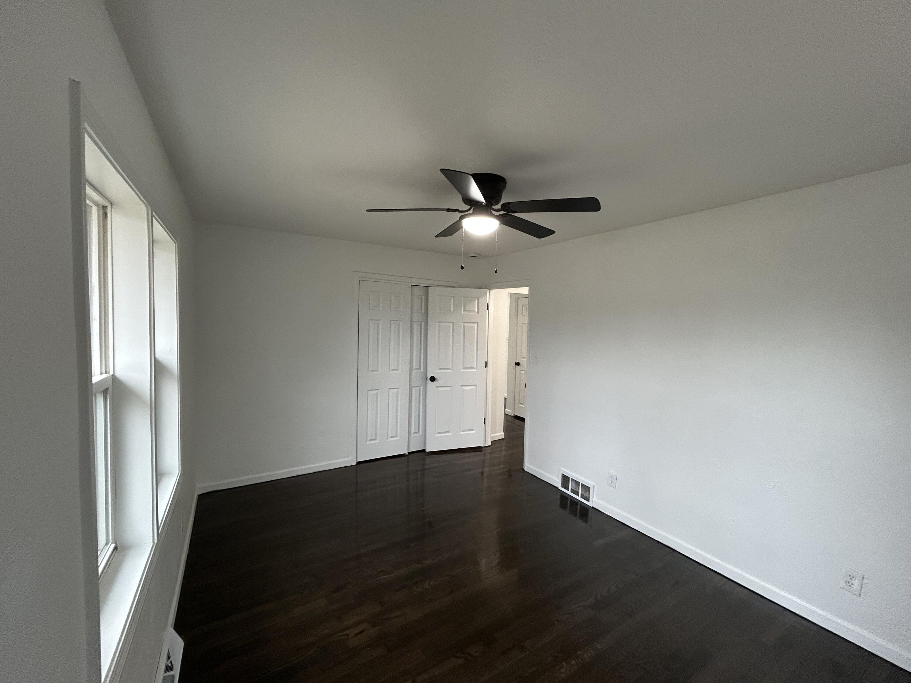 6701 Madison Street Merrillville, IN 46410 - Photo 6 of 25 an empty room with wooden floor and windows