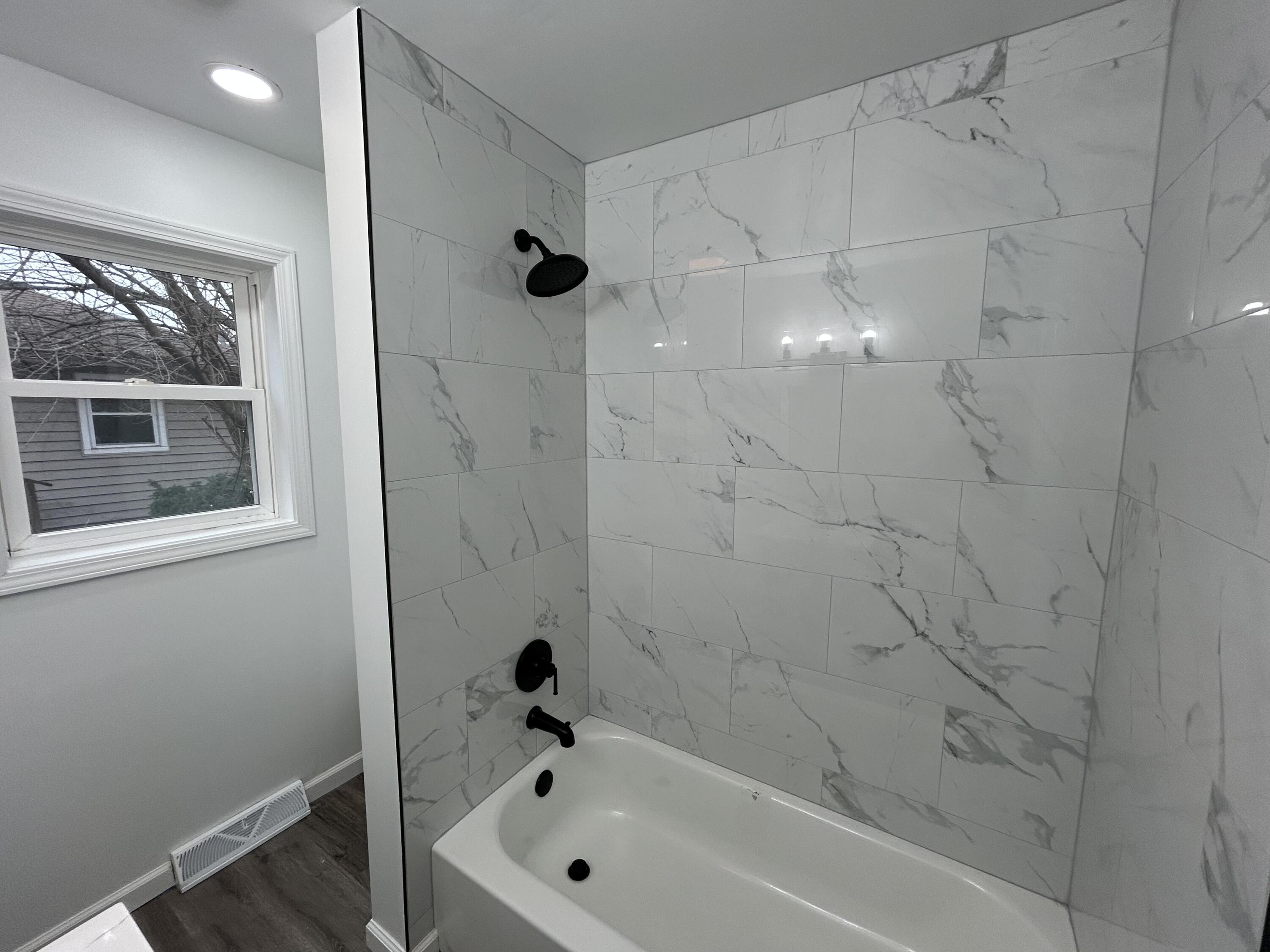 6701 Madison Street Merrillville, IN 46410 - Photo 8 of 25 a bathroom with a bathtub and a shower
