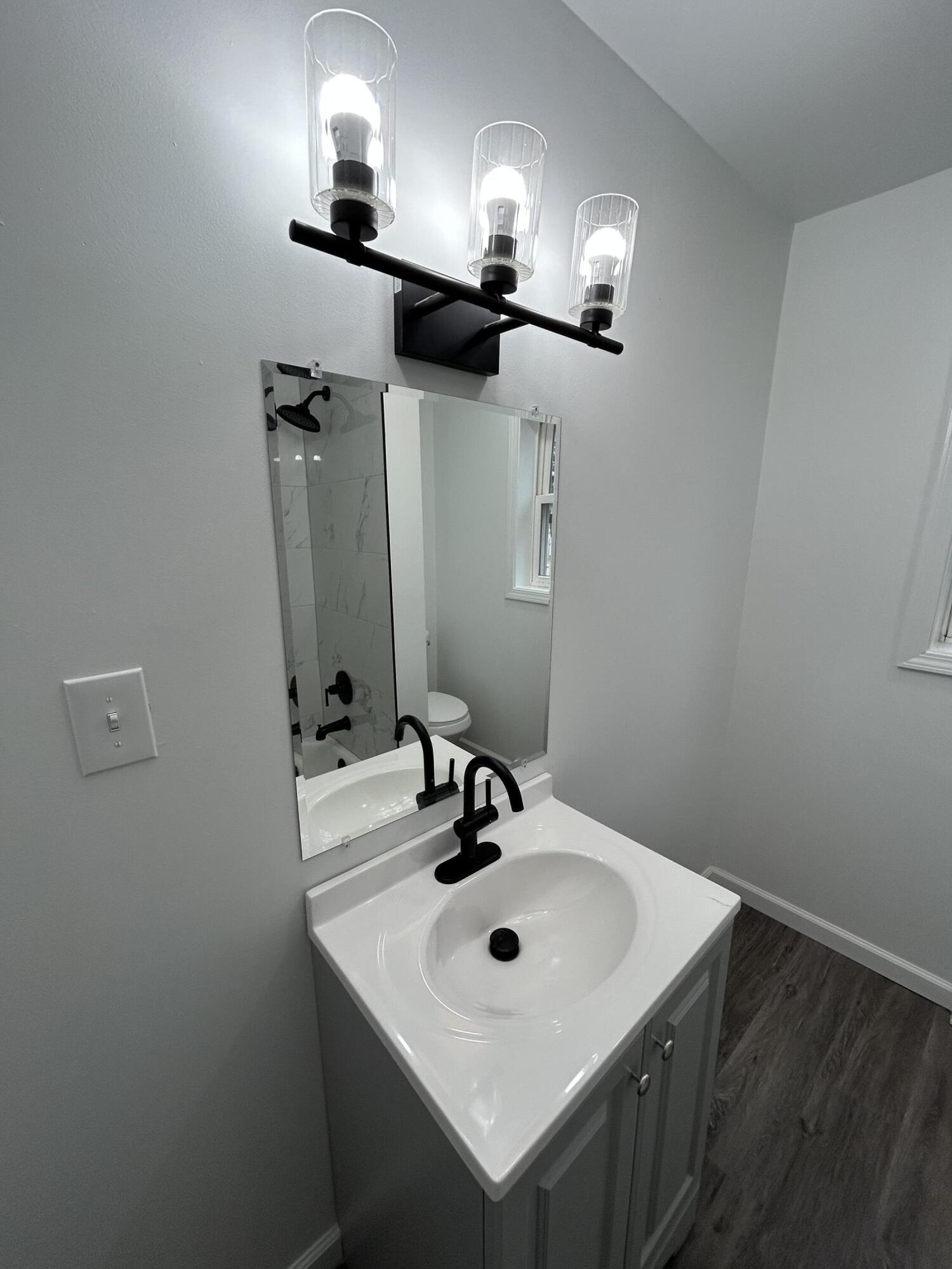 6701 Madison Street Merrillville, IN 46410 - Photo 9 of 25 a bathroom with a sink and a mirror