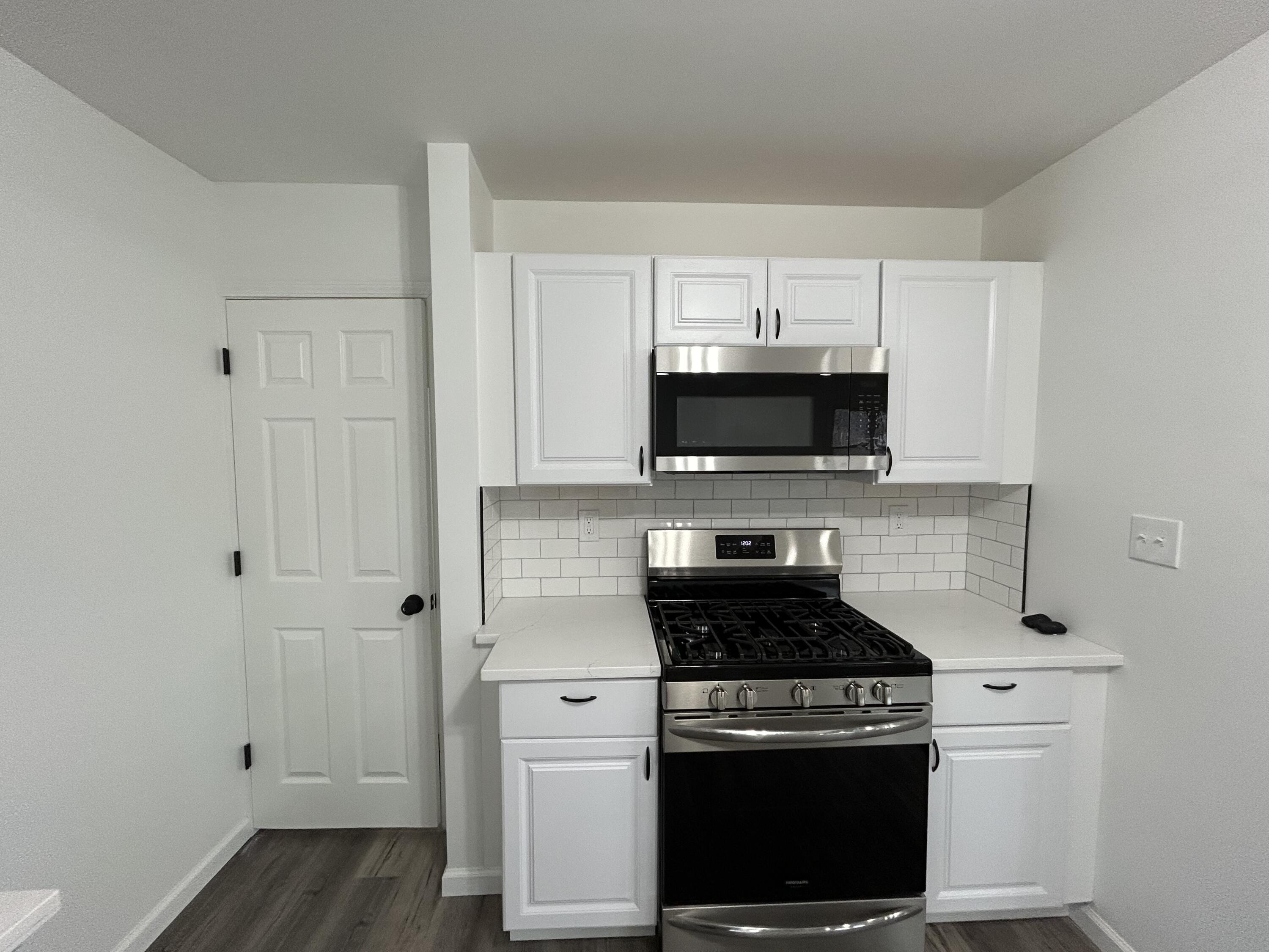 6701 Madison Street Merrillville, IN 46410 - Photo 10 of 25 a kitchen with stainless steel appliances a stove and a microwave