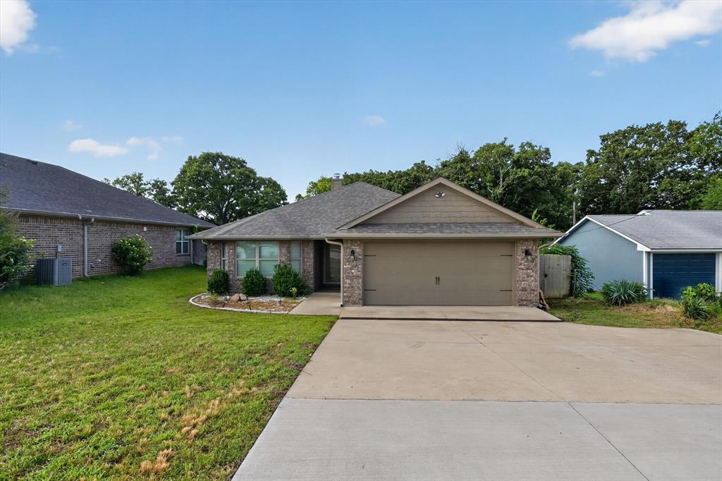 3016 Loy Lake Road Denison, TX 75020 - Photo 1 of 25 Brick facade residence with a two-car garage and a concrete driveway