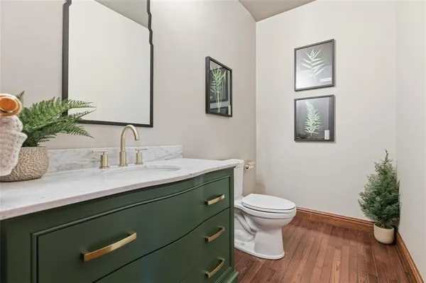 a bathroom with a sink toilet and a mirror