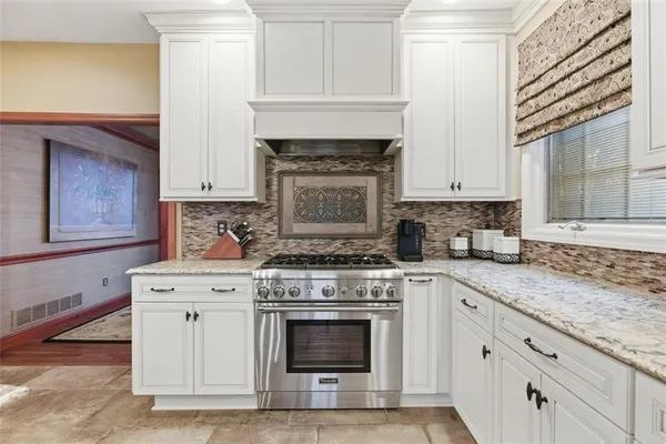 a kitchen with cabinets appliances and a sink