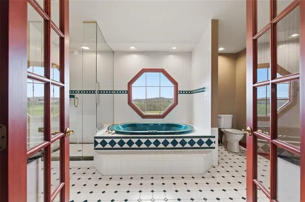 a bathroom with a glass shower door a sink and a mirror