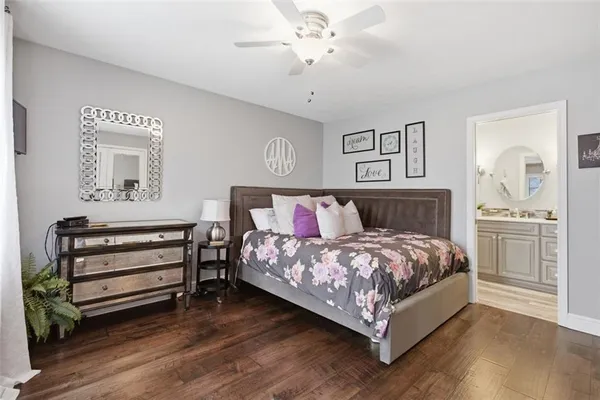 a bedroom with bed a mirror and window