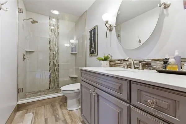 a living room with furniture a flat screen tv and a window